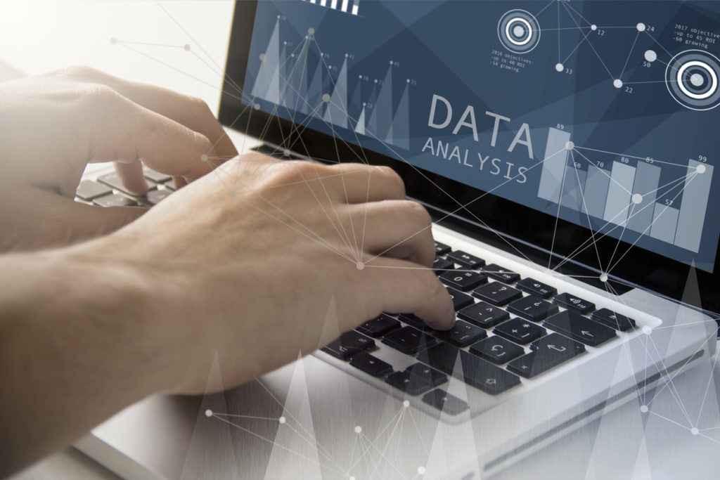 Man looking at data analytics and visualization tools on computer