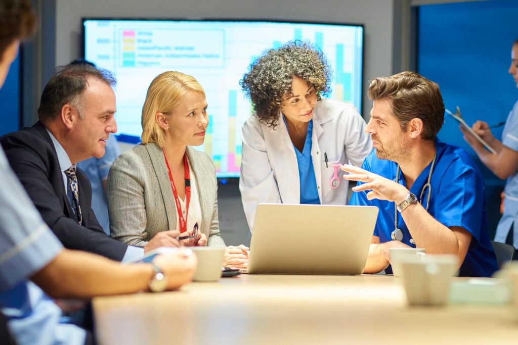 Healthcare professionals discussing legacy platforms in healthcare.