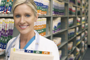 Smiling female doctor holding medical records.