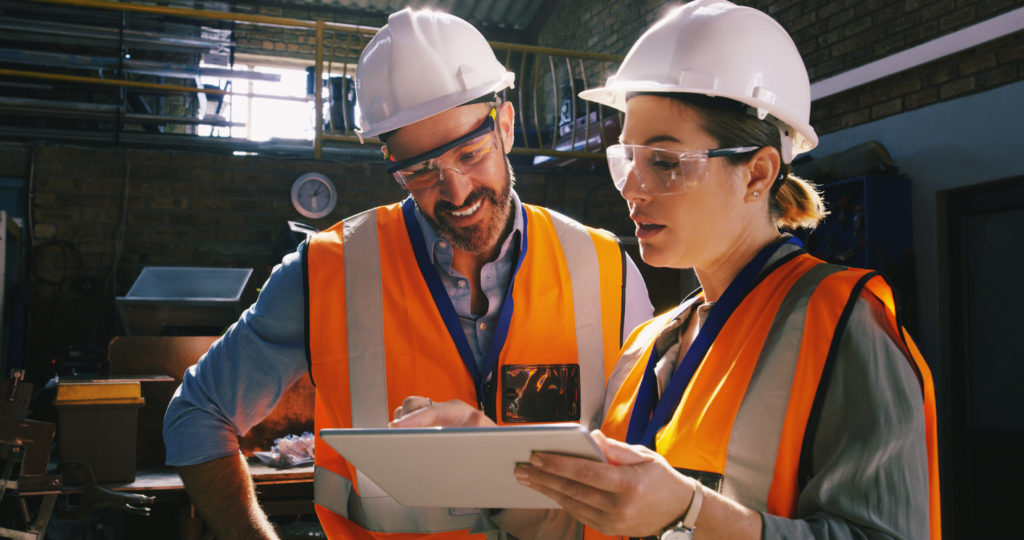 Two engineers using construction management apps.