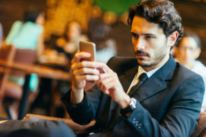 Young Millennial Businessman Using a Mobile App.