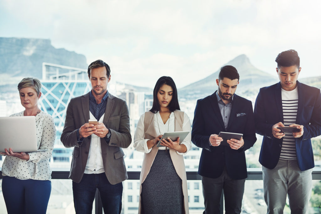 A group of business people using progressive web apps.
