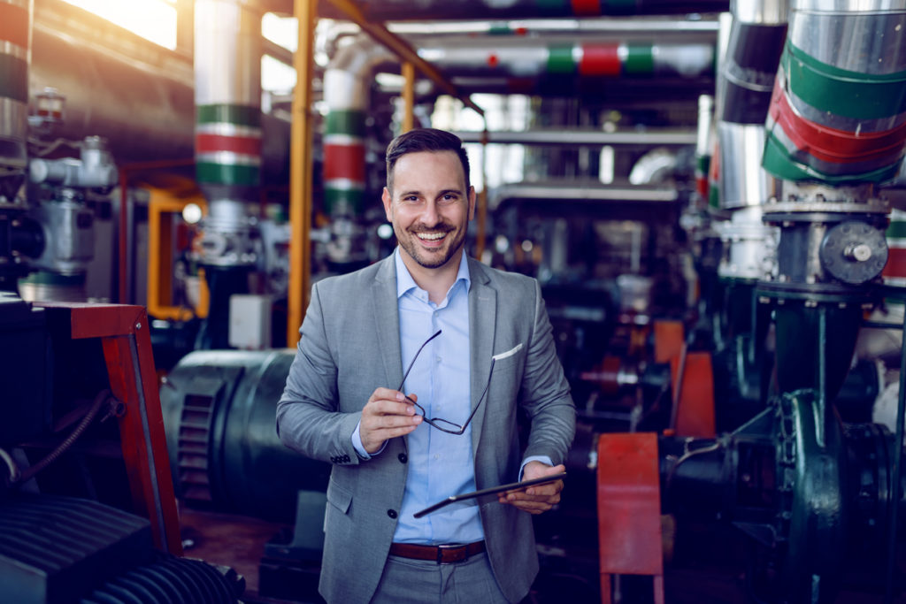 Smiling energy plant supervisor who is happy about app modernization.